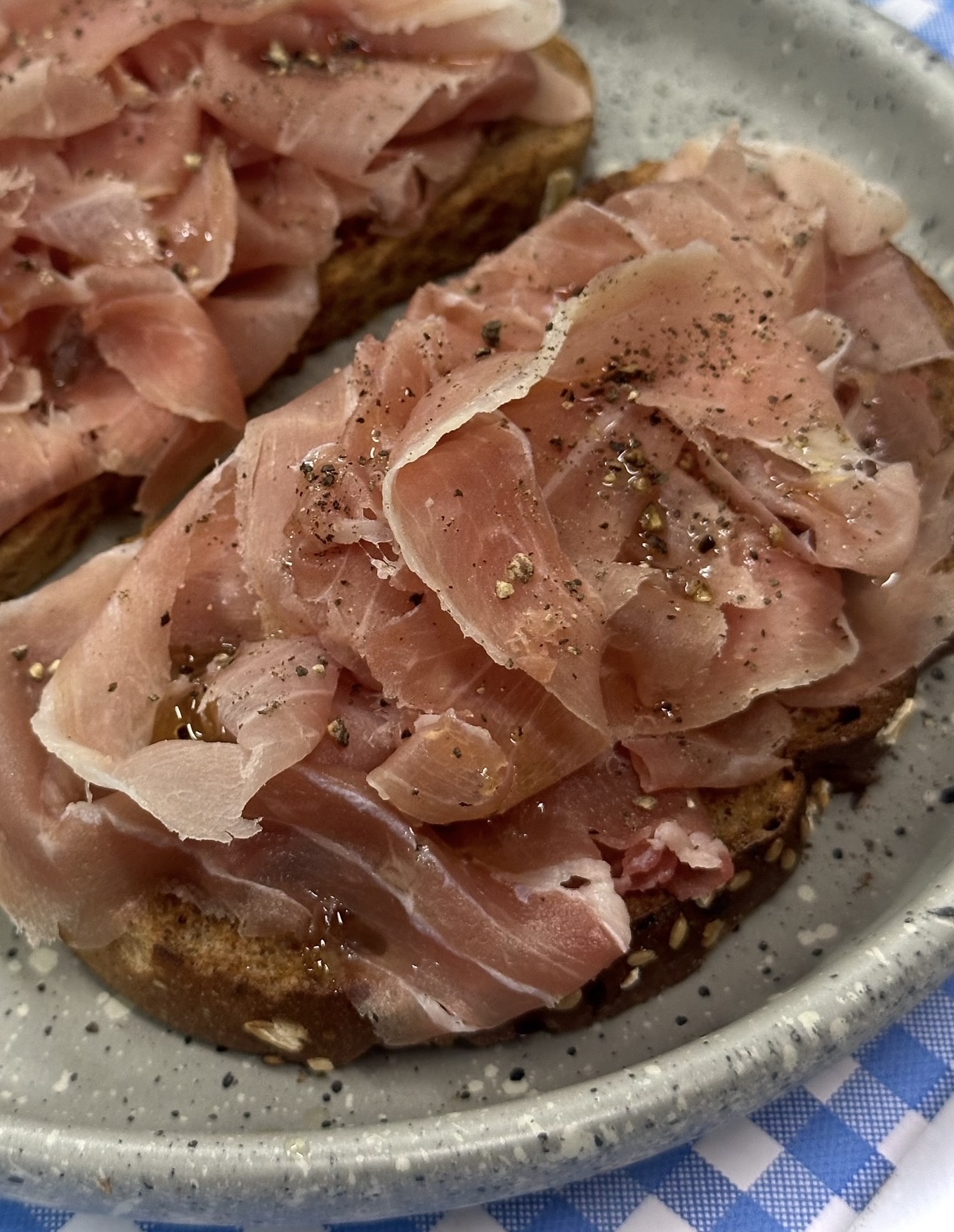 Bruschetta topped with thinly sliced prosciutto