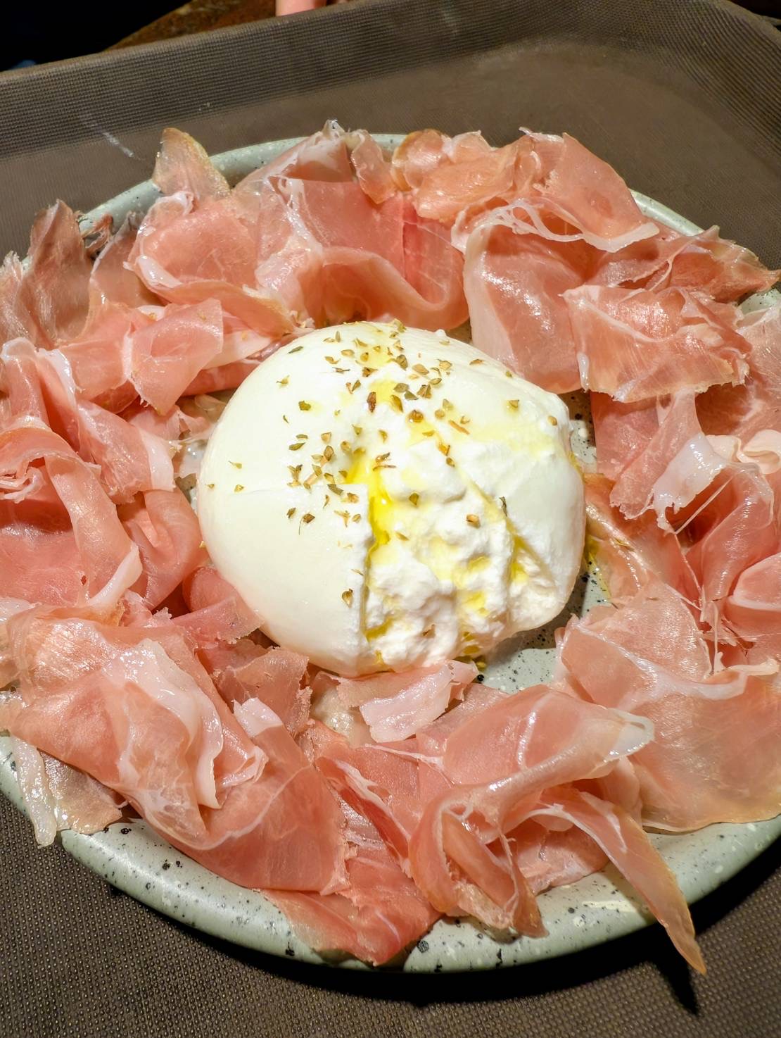 Crudo di Parma served with burrata