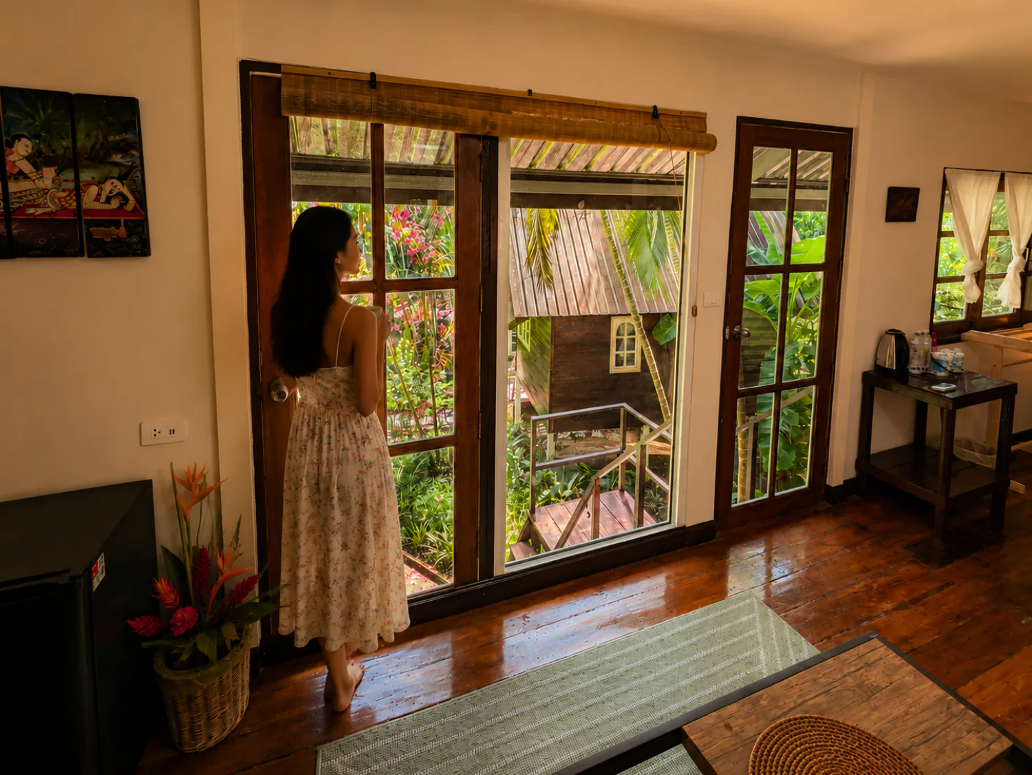Guest enjoying the panoramic garden view from inside a วิลลากลางสวน at Vanara Retreat